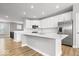 Open kitchen with large island, stainless steel appliances, and hardwood flooring at 13833 Tender Dr, Carmel, IN 46032