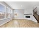 Bright and airy living room featuring large windows, a fireplace, and hardwood flooring at 13833 Tender Dr, Carmel, IN 46032