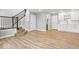Bright living area with hardwood floors, staircase and access to a modern bathroom and kitchen at 13833 Tender Dr, Carmel, IN 46032