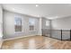 Bright living room with wood floors and large windows offering natural light at 13833 Tender Dr, Carmel, IN 46032