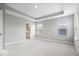 Large, bright main bedroom featuring a trey ceiling, neutral walls and plush carpet at 13833 Tender Dr, Carmel, IN 46032