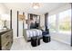 Well-lit bedroom featuring a twin daybed, striped wall accents, and decorative sports-themed art at 14477 Stairbridge Pl, Carmel, IN 46032