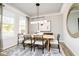 Bright dining area with natural light, stylish lighting, and seating for six around a wood table at 14477 Stairbridge Pl, Carmel, IN 46032