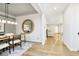 Open concept dining room with wood floors, modern lighting, and a clear view into the connected living spaces at 14477 Stairbridge Pl, Carmel, IN 46032