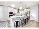 Modern kitchen featuring white cabinets, stainless steel appliances, and a large island with barstool seating at 14477 Stairbridge Pl, Carmel, IN 46032