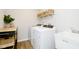 Well-equipped laundry room with modern appliances, sink, and storage baskets at 14477 Stairbridge Pl, Carmel, IN 46032
