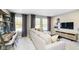 Cozy living room with large sofa, tv, desk, and natural light at 14477 Stairbridge Pl, Carmel, IN 46032