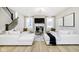 Bright living room with fireplace, large sofas, and an open staircase at 14477 Stairbridge Pl, Carmel, IN 46032
