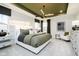 Beautiful bedroom with a unique ceiling design, stylish furnishings, and large windows at 14477 Stairbridge Pl, Carmel, IN 46032
