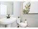 Clean powder room featuring a pedestal sink, modern fixtures, and contemporary decor for a sleek design at 14477 Stairbridge Pl, Carmel, IN 46032