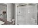 Clean bathroom showcasing a glass-enclosed shower with a built-in seat and coordinated white towels at 15206 Swallow Falls Way, Fishers, IN 46037