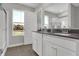 Bright bathroom featuring double sink vanity, and a view of a nature setting at 15206 Swallow Falls Way, Fishers, IN 46037