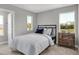 Neutral bedroom featuring a standard bed, two windows, and wood nightstand at 15206 Swallow Falls Way, Fishers, IN 46037