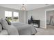 Bright bedroom featuring a modern light fixture and a large window with a neighborhood view at 15206 Swallow Falls Way, Fishers, IN 46037