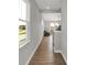 Elegant hallway featuring hardwood floors, ample natural light, and views into the living area at 15206 Swallow Falls Way, Fishers, IN 46037