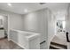 Well-lit upstairs hallway with access to bedrooms and bathrooms with carpeted floors at 15206 Swallow Falls Way, Fishers, IN 46037