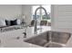 Modern kitchen with stainless steel sink, stylish faucet, and open layout for seamless entertaining and everyday living at 15206 Swallow Falls Way, Fishers, IN 46037