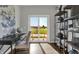 Bright home office space with desk, shelving, and sliding glass doors to outdoor patio at 15206 Swallow Falls Way, Fishers, IN 46037