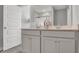 Modern bathroom featuring a dual sink vanity, modern mirror, and tiled floors at 15214 Swallow Falls Way, Fishers, IN 46037