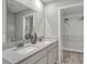Bathroom featuring dual sinks, white cabinets, quartz countertop and closet at 15214 Swallow Falls Way, Fishers, IN 46037