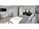 A view of a modern bedroom featuring two armchairs and a mounted TV at 15214 Swallow Falls Way, Fishers, IN 46037