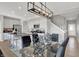 Open concept kitchen and dining room with island, stainless appliances, and modern lighting at 15214 Swallow Falls Way, Fishers, IN 46037