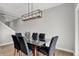 Dining room features modern lighting and a glass table with seating for six at 15214 Swallow Falls Way, Fishers, IN 46037