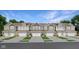 Row of three-story townhomes featuring unique exteriors, garages, and well-manicured lawns and a blue sky at 15214 Swallow Falls Way, Fishers, IN 46037