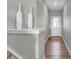 Hallway boasts sleek, modern design with hardwood floors and tasteful decor at 15214 Swallow Falls Way, Fishers, IN 46037