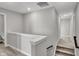 Bright upstairs hallway with a view of the stairs and neutral color scheme at 15214 Swallow Falls Way, Fishers, IN 46037