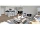 Modern living room and kitchen combo with a gray sofa, stylish decor, and a dining area at 15214 Swallow Falls Way, Fishers, IN 46037