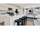 Modern kitchen boasts white cabinets, stainless steel appliances, quartz counters, and island with seating at 15294 Swallow Falls Way, Fishers, IN 46037