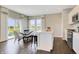 Open concept kitchen features large island, stainless steel appliances and adjacent dining area with outdoor views at 15294 Swallow Falls Way, Fishers, IN 46037