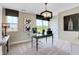 A cozy office space includes a glass desk, modern lighting, and views of the community from two windows at 15294 Swallow Falls Way, Fishers, IN 46037