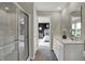 Bright bathroom featuring double vanity, glass shower and view into the main bedroom at 15310 Swallow Falls Way, Fishers, IN 46037