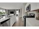 Modern kitchen with stainless appliances and open concept layout into living area at 15310 Swallow Falls Way, Fishers, IN 46037