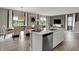 Open concept kitchen features stainless appliances and a large island sink area at 15310 Swallow Falls Way, Fishers, IN 46037