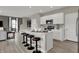 Modern kitchen island with seating and stainless steel appliances in open floor plan at 15310 Swallow Falls Way, Fishers, IN 46037