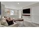 Relaxing loft area with sectional sofa, accent tables, and flat screen TV at 15310 Swallow Falls Way, Fishers, IN 46037