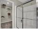 Bright walk in shower with a glass door and view into a walk in closet at 15310 Swallow Falls Way, Fishers, IN 46037