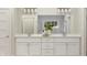 Double sink bathroom vanity with white cabinets, granite countertops, and large mirror at 15384 Cardonia Rd, Fishers, IN 46037