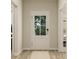Bright entryway with a glass-paneled door, light wood floors, and neutral walls at 15384 Cardonia Rd, Fishers, IN 46037