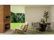 Modern living room showcasing a fireplace, chair, and dining table with chairs and decorative plants at 15384 Cardonia Rd, Fishers, IN 46037
