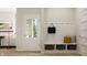 Mudroom featuring built-in bench with storage, coat hooks, and access to the living room at 15384 Cardonia Rd, Fishers, IN 46037