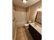 Bathroom features a vanity and a tub/shower combo with tan colored tile flooring at 1657 Park Terrace Ct, Indianapolis, IN 46229
