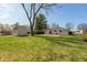 Home's backyard offers mature trees, a shed, and an area that could be a patio at 1665 South Dr, Columbus, IN 47203