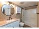 Bright bathroom featuring stylish vanity with granite top and a shower with modern fixtures at 1665 South Dr, Columbus, IN 47203