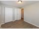 Bright bedroom features wood-look floors, neutral paint, and closet for ample storage at 1665 South Dr, Columbus, IN 47203