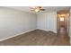 Spacious bedroom with clean gray walls, modern ceiling fan, wood-look flooring, and ample closet space at 1665 South Dr, Columbus, IN 47203