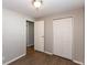 This bedroom features neutral colors, a closet, and wood-look floors at 1665 South Dr, Columbus, IN 47203